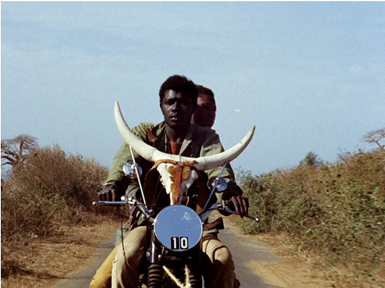 Two men of color riding a motorcycle