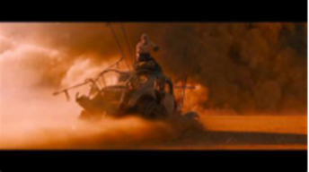 Furiosa drives the War Rig into a sandstorm, symbolizing her break from the world of control and violence.