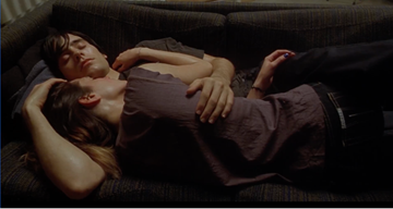 Two people cuddling on a couch
